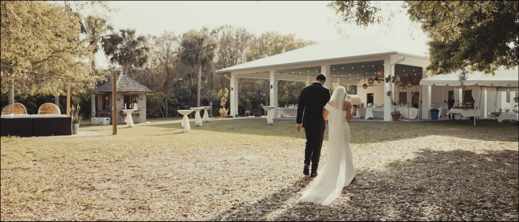 Bride and groom walking through the grounds at Treehouse Vero Beach