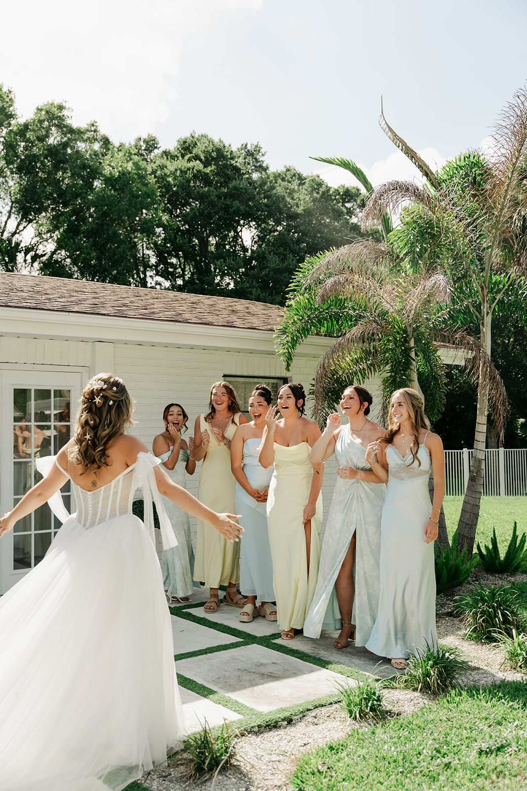 Bridesmaids reacting as the bride approaches before the ceremony
