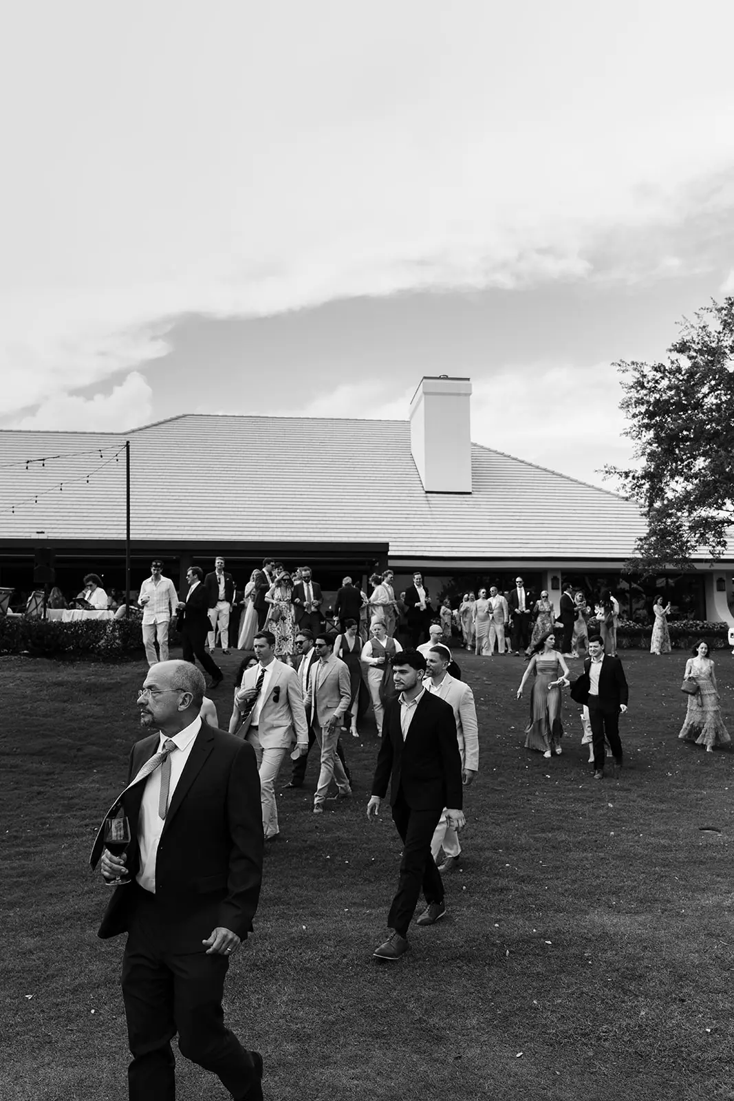 Wedding party walking across the lawn at Bent Pine Golf Club