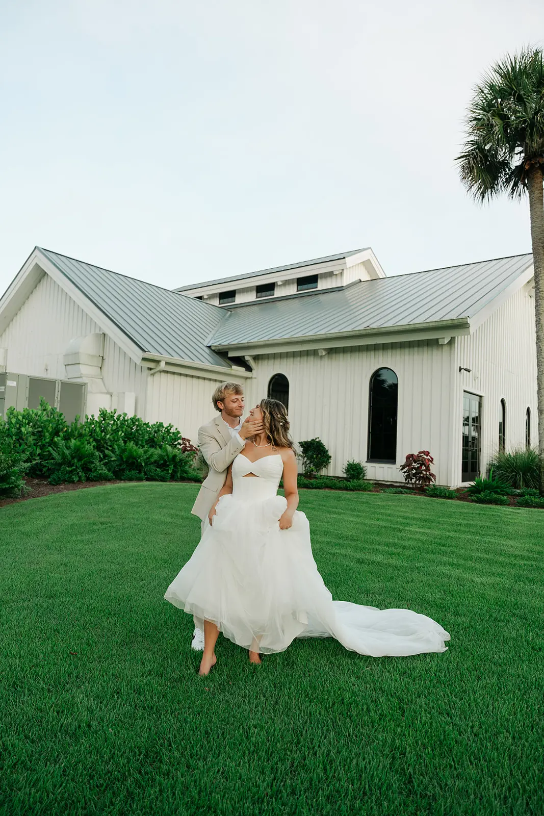 Bride and groom standing on the lawn at Celebration Grove in Vero Beach